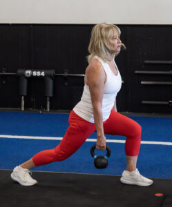 How to stick to a fitness plan — woman training with kettlebell at Block Fitness in Tucson