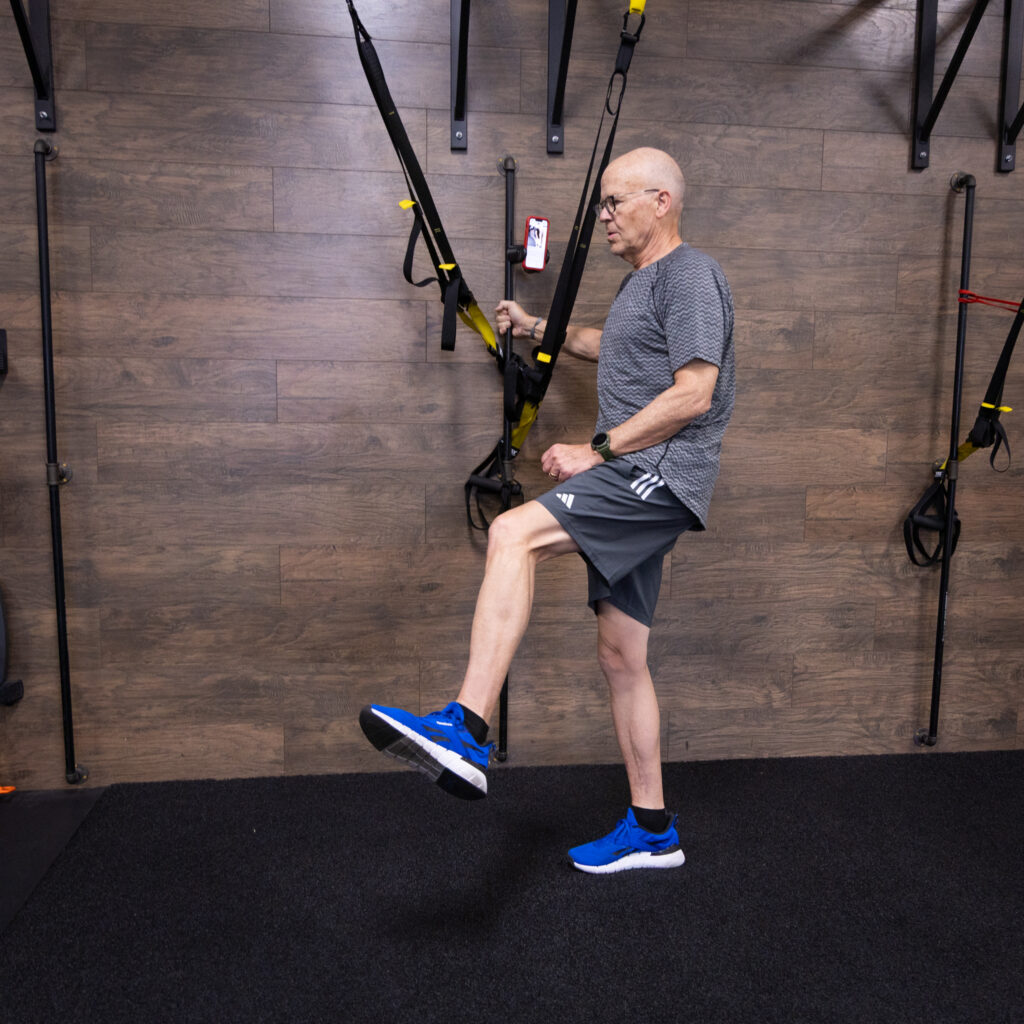 Masters athlete doing strength training after injury with coach support